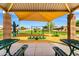 Community playground with sun shade, picnic benches and modern, colorful play equipment at 1347 E Vernoa St, San Tan Valley, AZ 85140