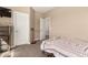 Carpeted bedroom with closet, open door and dresser at 1367 S Country Club Dr # 1295, Mesa, AZ 85210