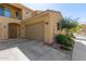 Exterior view of a home featuring a convenient attached garage and an arched doorway at 1367 S Country Club Dr # 1295, Mesa, AZ 85210