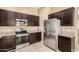 Modern kitchen equipped with stainless steel appliances, granite countertops, and tile flooring at 1367 S Country Club Dr # 1295, Mesa, AZ 85210