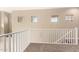 Upstairs loft area featuring multiple windows with natural lighting and a white railing at 1367 S Country Club Dr # 1295, Mesa, AZ 85210