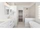 Modern bathroom features double sinks, elegant mirrors, and a luxurious standalone tub and shower at 1430 E Douglas St, Casa Grande, AZ 85122