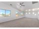 Spacious primary bedroom with large windows offering ample natural light and a ceiling fan at 1430 E Douglas St, Casa Grande, AZ 85122