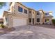 Modern two-story home with an attached garage, desert landscaping, and wide driveway at 1430 E Douglas St, Casa Grande, AZ 85122