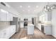 Well-lit kitchen with white cabinets, stainless steel appliances, and functional island space at 1430 E Douglas St, Casa Grande, AZ 85122