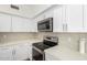 Stylish kitchen showcasing stainless steel appliances, white cabinets, and elegant countertop at 1430 E Douglas St, Casa Grande, AZ 85122