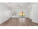 Bright living room featuring wood-look floors, recessed lighting, and access to the backyard at 1430 E Douglas St, Casa Grande, AZ 85122