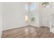 Bright living room with wood floors, large windows, and a soaring ceiling at 1430 E Douglas St, Casa Grande, AZ 85122