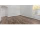 Bright living room with wood floors, white walls, and natural light from a large window at 1430 E Douglas St, Casa Grande, AZ 85122