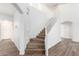 Bright stairway featuring wood stairs, white walls, and railing leading to the second story at 1430 E Douglas St, Casa Grande, AZ 85122