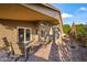 Spacious backyard patio with outdoor seating and shade umbrellas; perfect for entertaining at 15149 W Vale Dr, Goodyear, AZ 85395