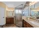 Elegant bathroom features a large glass-enclosed shower and dual vanities with granite countertops at 15149 W Vale Dr, Goodyear, AZ 85395