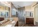 Spa-like bathroom boasts a glass-enclosed shower and dual vanities, designed for ultimate relaxation at 15149 W Vale Dr, Goodyear, AZ 85395