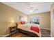 Inviting bedroom with a window view, ceiling fan and lamps on the nightstands at 15149 W Vale Dr, Goodyear, AZ 85395