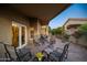 Inviting covered patio with brick flooring and comfortable seating, perfect for relaxation at 15149 W Vale Dr, Goodyear, AZ 85395