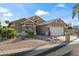 Well-maintained home boasting a two-car garage, desert landscaping, and tiled roof in a friendly neighborhood at 15149 W Vale Dr, Goodyear, AZ 85395
