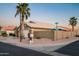 Charming single story home on a corner lot with desert landscaping and a palm tree at 15149 W Vale Dr, Goodyear, AZ 85395