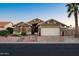 Charming single-story home with a two-car garage, desert landscaping, and a well-maintained front yard at 15149 W Vale Dr, Goodyear, AZ 85395