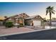 Lovely single-story home with a two-car garage, desert landscaping, and a palm tree at 15149 W Vale Dr, Goodyear, AZ 85395