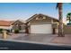 Beautiful single-story home with two-car garage, potted plants, and desert landscaping at 15149 W Vale Dr, Goodyear, AZ 85395