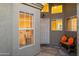 Inviting front porch with tile flooring, security door, and a cozy bench with cushions at 15149 W Vale Dr, Goodyear, AZ 85395