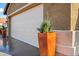 Attached two car garage with a white door and desert landscaping at 15149 W Vale Dr, Goodyear, AZ 85395