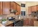 Well-equipped kitchen features granite counters, custom cabinets, and stainless steel appliances for modern convenience at 15149 W Vale Dr, Goodyear, AZ 85395