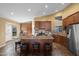 Eat-in kitchen with a center island, stainless steel appliances, and ample cabinet space at 15149 W Vale Dr, Goodyear, AZ 85395