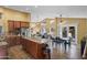 Open-concept kitchen and dining area with stainless steel appliances and a center island with bar seating at 15149 W Vale Dr, Goodyear, AZ 85395