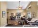 Open-concept living room with high ceilings, a fan, and a stone fireplace at 15149 W Vale Dr, Goodyear, AZ 85395