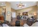 Large living room with a ceiling fan, fireplace, and plenty of comfortable seating at 15149 W Vale Dr, Goodyear, AZ 85395