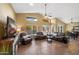 Spacious living room with a fireplace, vaulted ceiling, and tile flooring at 15149 W Vale Dr, Goodyear, AZ 85395
