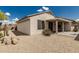 Desert backyard featuring gravel and plants with a covered patio area for outdoor relaxation at 15885 W Remington Dr, Surprise, AZ 85374