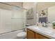 Bathroom featuring a shower and vanity with a granite countertop, combining style and functionality at 15885 W Remington Dr, Surprise, AZ 85374