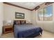 Inviting bedroom with a comfortable bed, a ceiling fan, and a window offering natural light at 15885 W Remington Dr, Surprise, AZ 85374