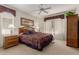 Cozy bedroom with a ceiling fan, and natural light from the window at 15885 W Remington Dr, Surprise, AZ 85374