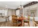 Charming dining area features a wood table, chandelier, and sliding doors to the outdoor patio at 15885 W Remington Dr, Surprise, AZ 85374