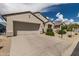 Beautiful single-story home with stucco exterior, a two-car garage, and manicured landscaping at 15885 W Remington Dr, Surprise, AZ 85374