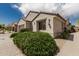 Charming home with a light stucco exterior, tile roof, and lush landscaping at 15885 W Remington Dr, Surprise, AZ 85374