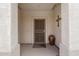 Covered front porch with decorative security door and columns, offering inviting curb appeal at 15885 W Remington Dr, Surprise, AZ 85374