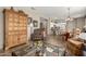 Open living space with hardwood floors connecting the living room, dining area, and kitchen at 15885 W Remington Dr, Surprise, AZ 85374