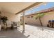 Relaxing outdoor patio area with comfortable seating and a view of lush desert landscaping at 15885 W Remington Dr, Surprise, AZ 85374