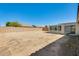 Large, blank canvas backyard featuring an enclosed patio and perimeter block wall at 16034 W Carmen Dr, Surprise, AZ 85374