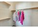 Walk-in closet with built-in shelving and wooden rods for organized storage at 16034 W Carmen Dr, Surprise, AZ 85374
