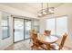 Inviting dining area with sliding doors to the enclosed porch offering ample natural light at 16034 W Carmen Dr, Surprise, AZ 85374
