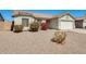 Charming single-story home featuring a two-car garage and low maintenance desert landscaping at 16034 W Carmen Dr, Surprise, AZ 85374