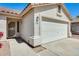 Close up of a charming single-story home featuring a two-car garage and low maintenance desert landscaping at 16034 W Carmen Dr, Surprise, AZ 85374