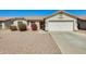 Charming single-story home featuring a two-car garage and low maintenance desert landscaping at 16034 W Carmen Dr, Surprise, AZ 85374