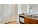 Kitchen showcasing stainless steel sink, wood cabinetry, and white appliances at 16034 W Carmen Dr, Surprise, AZ 85374