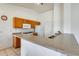 Kitchen featuring wood cabinets, tile flooring, and a breakfast bar for casual dining at 16034 W Carmen Dr, Surprise, AZ 85374